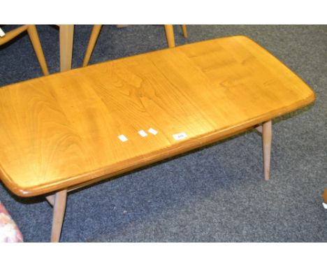 An Ercol low oval elm coffee table, c.1960