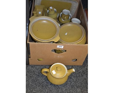 A Denby tea and part dinner service, mustard ground, comprising teacups and saucers, teapot, milk jug, covered serving dishes