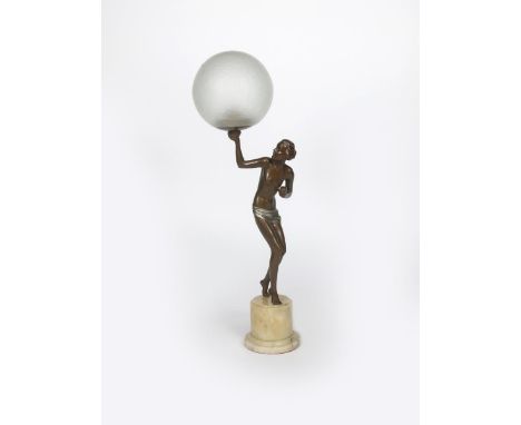 A patinated metal figural lamp, modelled as a woman holding up a frosted glass ball shade, on onyx base, unsigned, 61cm. high