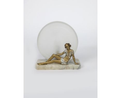 A patinated metal figural table lamp in the manner of Josef Lorenzl,  the figure modelled lying and resting, on alabaster bas