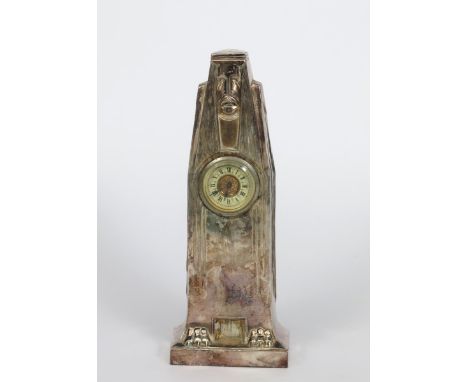 A Urania electroplated mantel clock, model no.1147, tapering rectangular form, cast with an Aztec mask with long straight hai