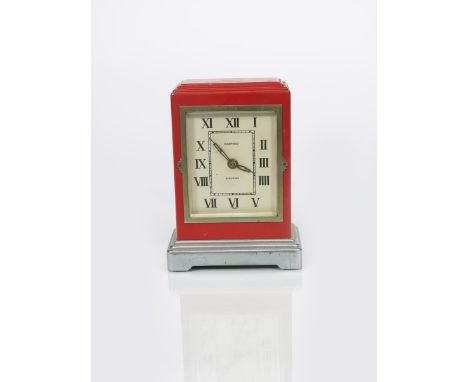 A French electric mantel clock, rectangular pillar box red body with stepped top, on stepped polished metal foot, the rectang