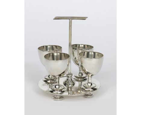An electroplated egg cup and stand in the manner of Dr Christopher Dresser, model W5582, pierced, circular base on bun feet, 