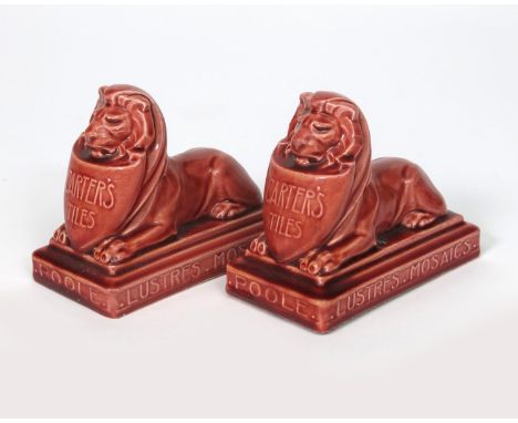 'Carter's Tiles' a Carter's Poole Pottery advertising paperweight, modelled as a lion lying, holding a shield inscribed Carte