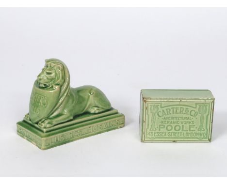 'Carter's Tiles' a Carter's Poole Pottery advertising paperweight, modelled as a lion lying, holding a shield inscribed Carte