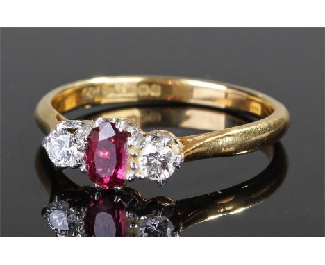 18 carat gold diamond and ruby ring, the central ruby flanked by two diamonds, ring size T
