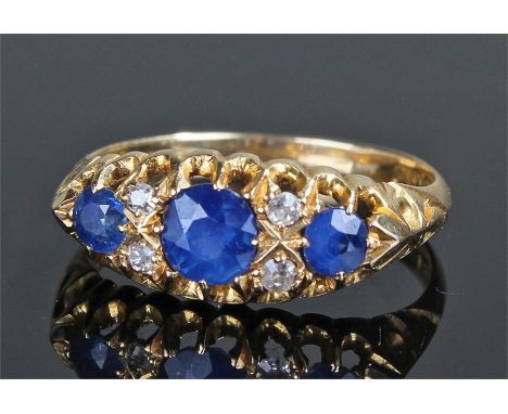 18 carat gold sapphire and diamond ring, with three sapphires and four diamonds, ring size M