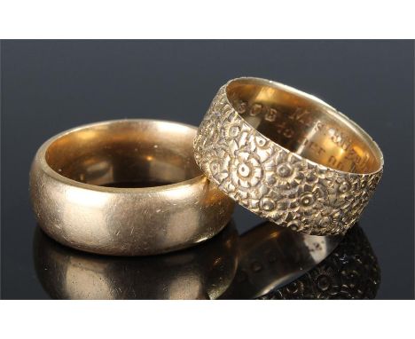 Two 18 carat gold wedding bands, the first with outer flower effect, inscription to the centre, the second plain, total weigh