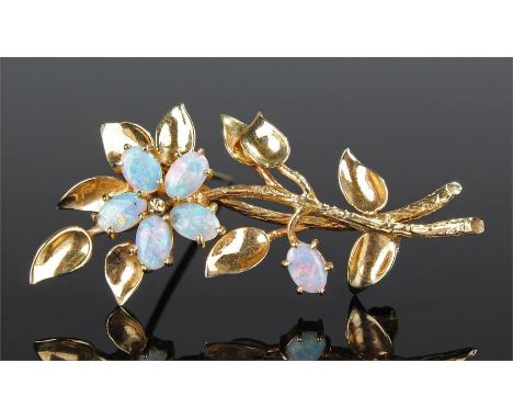 9 carat gold opal set brooch, the leaf design with an opal set flower head, 52mm high