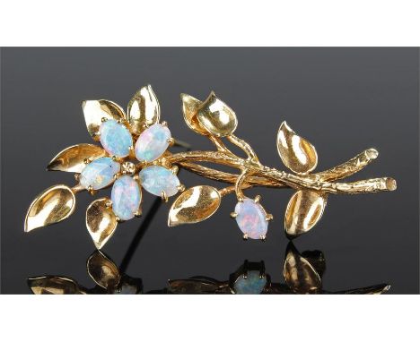 9 carat gold opal set brooch, the leaf design with an opal set flower head, 52mm high