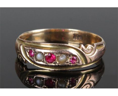 18 carat gold pearl and ruby ring, with scroll shoulders, mounted with two pearls and three rubies, ring size W