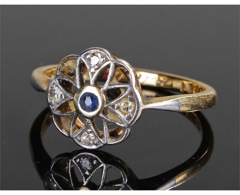 18 carat gold diamond and sapphire ring, with a central sapphire outer flower design set with four diamonds, ring size M
