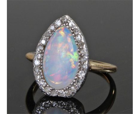 Yellow metal diamond and opal ring, the pear shape opal and mount set with diamonds, ring size L