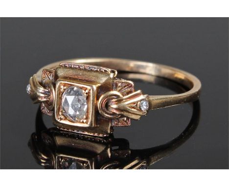 Yellow metal diamond set ring, the central diamond with a further two diamonds to the shaped shoudlers, ring size Q