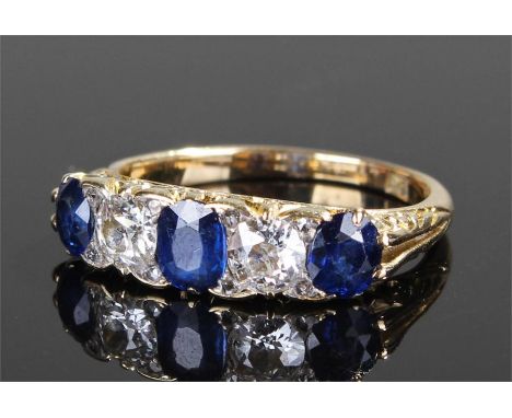 18 carat gold sapphire and diamond ring, with three sapphires separated by two diamonds, ring size L