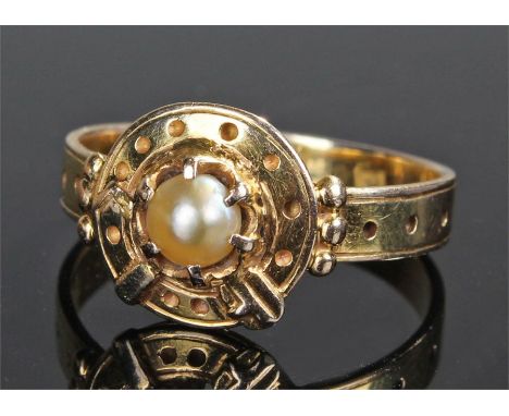 Yellow metal pearl set ring, the central pearl with belt and buckle design mount, ring size Q