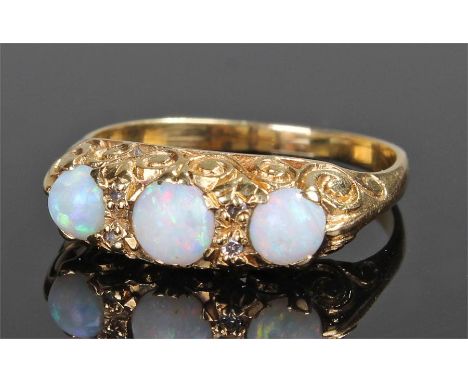 18 carat gold opal set ring, with three opals on scroll mount, ring size R