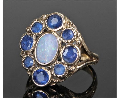 9 carat gold opal and sapphire ring, with a central opal surrounded with eight sapphires, ring size Q 1/2