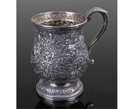 Late 19th Century Indian silver tankard, with embossed decoration of animals hunting among flowers and branches, 11cm high, 7