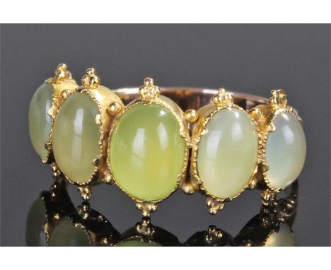 Yellow metal pale green opal set ring, with a row of five opals, ring size Q