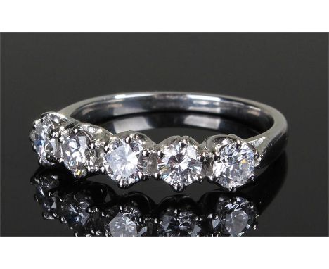 White metal diamond set ring, with a row of five diamonds at 1.2 carats, ring size S