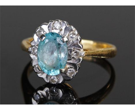 18 carat gold diamond stone set ring, the central blue stone surrounded with diamonds, ring size F