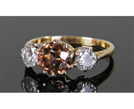 Three stone diamond ring, the central 1.66 carat brilliant cut cinnamon diamond flanked by two further diamonds approximately