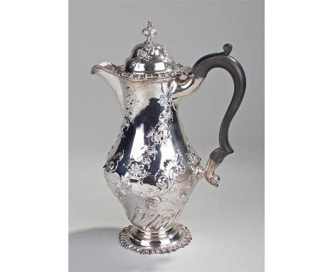 Edward VII silver hot water jug, London, 1902, maker Walter & Charles Sissons, the finial top above a foliate embossed lid an