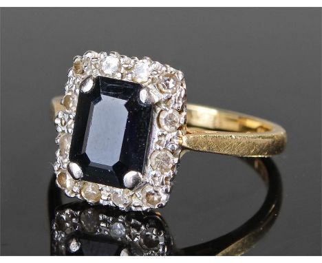 18 carat gold sapphire and diamond ring, the central sapphire flanked by diamonds, ring size M