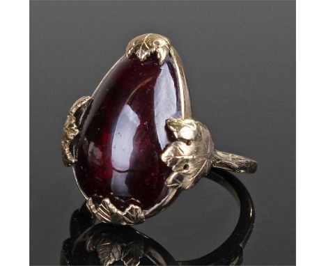 9 carat gold stone set ring, the large pear shape red stone with leaf mounts, ring size R