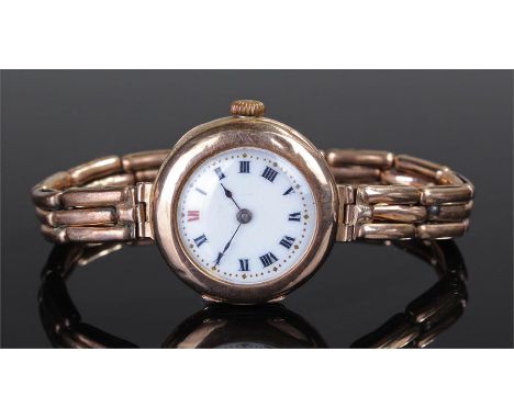 9 carat gold ladies wristwatch, with a white enamel dial, Roman hours, 9 carat gold elasticated strap, case 27mm diameter