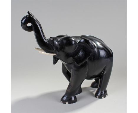 Ceylonese ebony elephant, of large proportions, twisted trunk in a walking stance, 47cm long