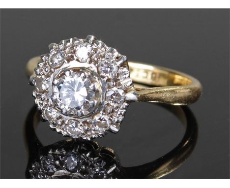 18 carat gold diamond ring, in the form of a flower head, with a central diamond surrounded by diamonds, ring size K 1/2