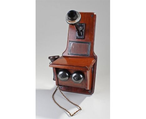 1940's wall mounted telephone, the mahogany back with receiver and speaker, two bells below, 45cm high