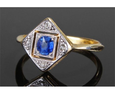 18 carat gold sapphire and diamond ring, the oval sapphire in a square mount, diamonds to the corners, ring size M