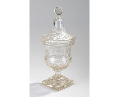 19th Century cut glass vase and cover, the glass with a yellow tint, the finial top above a geometric design cover and body, 