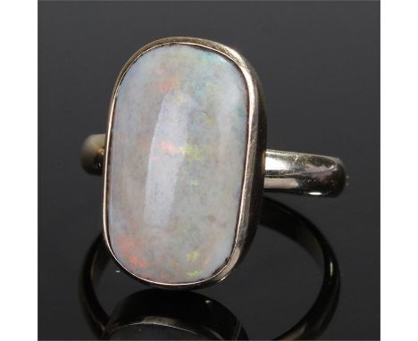 Yellow metal opal set ring, the shaped rectangular opal with a yellow metal mount, ring size U