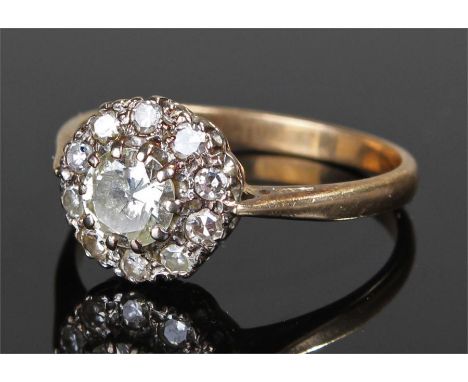 18 carat gold diamond set ring, the central approximately 0.60 carat diamond, surrounded by a further ten diamonds , ring siz