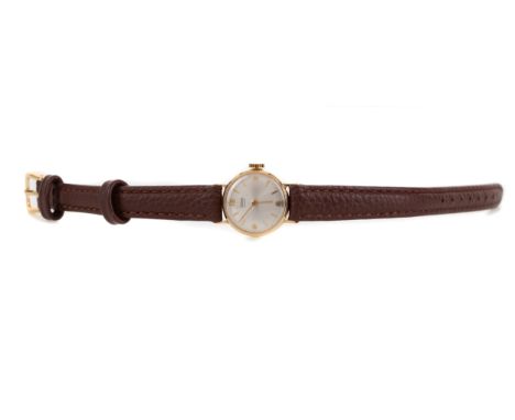the round dial with Arabic and baton hour markers, 18mm case, on a brown leather strap, lacking box and papers  MOVEMENT: Not