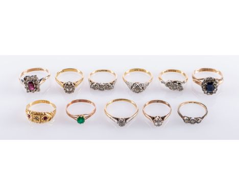 A collection of eleven gem set rings, including three illusion set three stone diamond rings, ring size J1/2, K, K,; two sing