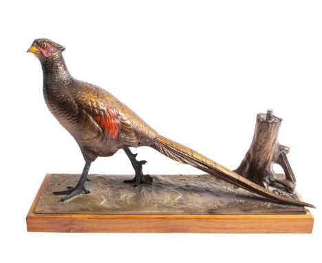An Austrian cold painted spelter table lighter modelled as a pheasant beside a tree stump, 20th century; the striker housed i