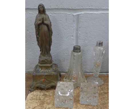 A silver topped bottle and vintage ink wells with a French Madonna statue 