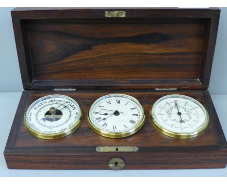 A boxed set of clock/barometer and temperature gauge 