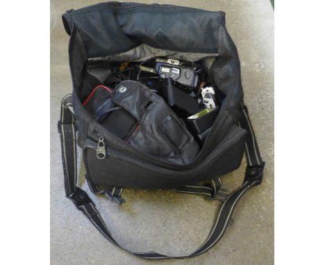 A bag of mixed cameras, compact cameras, SLR cameras, flash units, etc. 