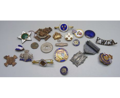 A collection of military pin badges and other badges including enamel 