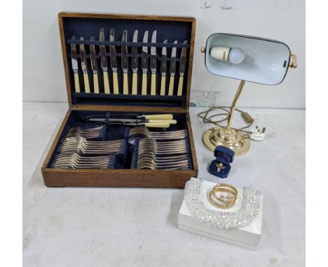 A mixed lot to include a Morden library lamp, along with a canteen of cutlery, a gold on silver brooch and others Location: 