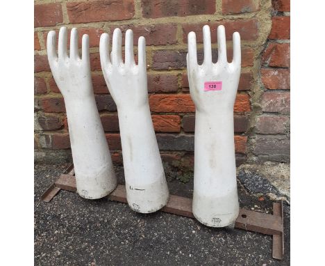 A set of three vintage ceramic latex glove moulds on a metal stand produced by AHGLocation: RAB 