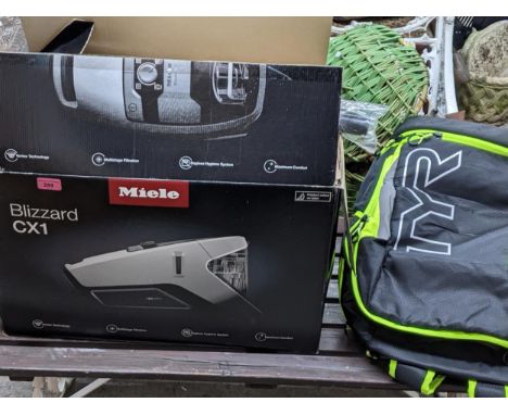 A boxed Miele vacuum cleaner model Blizz Cat and Dog Pro with instruction leaflet and guarantee, along with a TYR rucksack Lo