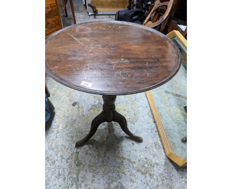 A Georgian mahogany tilt top table with circular top having moulded edge, on turned column and pedestal tripod base Location: