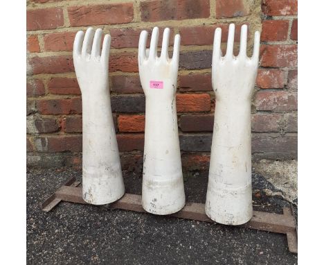 A set of three vintage ceramic latex glove moulds, on a mal stand produced by AHGLocation: RAB 